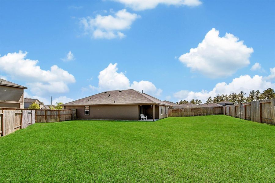 Exterior details and patio area of a home in The Canopies, Splendora (Image 23).