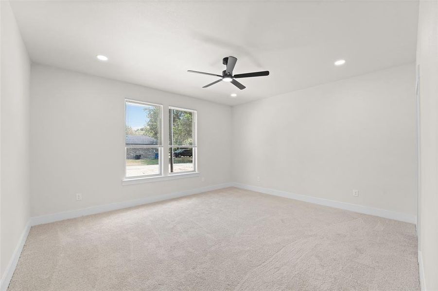 Light-filled room featuring plush carpet flooring, recessed lighting, and a contemporary ceiling fan Light-filled room featuring plush carpet flooring, recessed lighting, and a contemporary ceiling fan