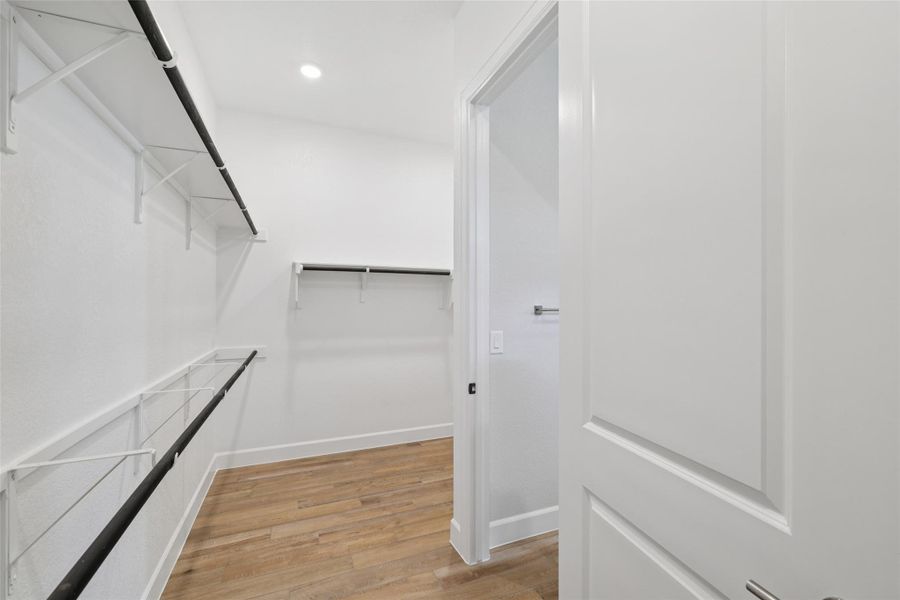 Spacious closet with light wood finished floors