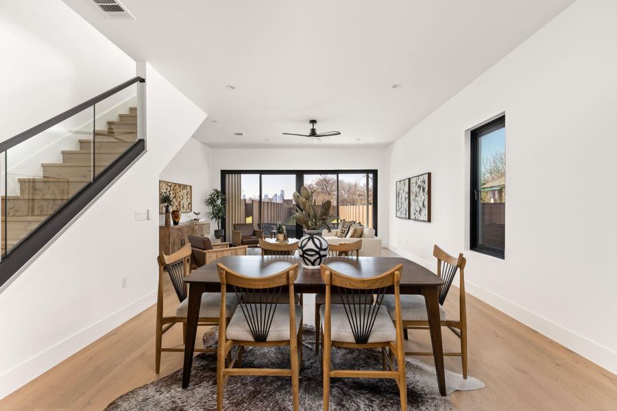 Dining area featuring light wood finished floors and a ceiling fan