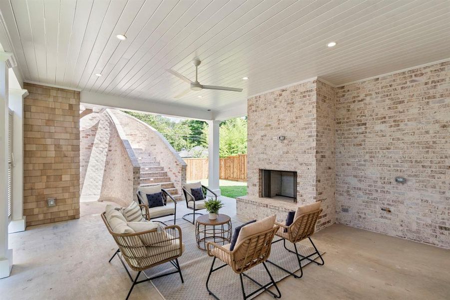 View of patio / terrace featuring an outdoor living space with a fireplace and ceiling fan