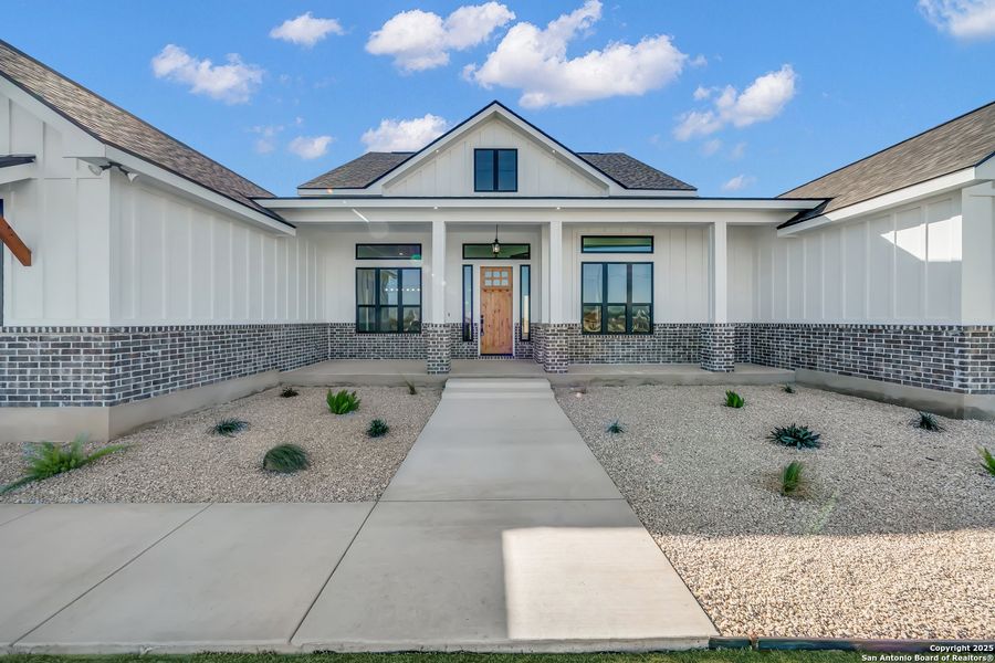 Front exterior of a new home in , La Vernia, TX, highlighting curb appeal (Image 28).