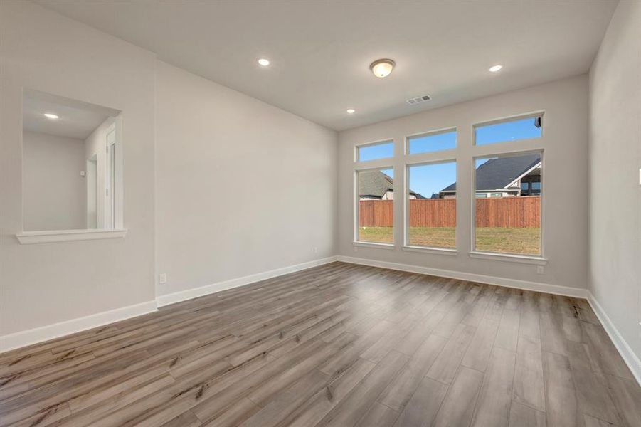 Empty room featuring wood finished floors and recessed lighting