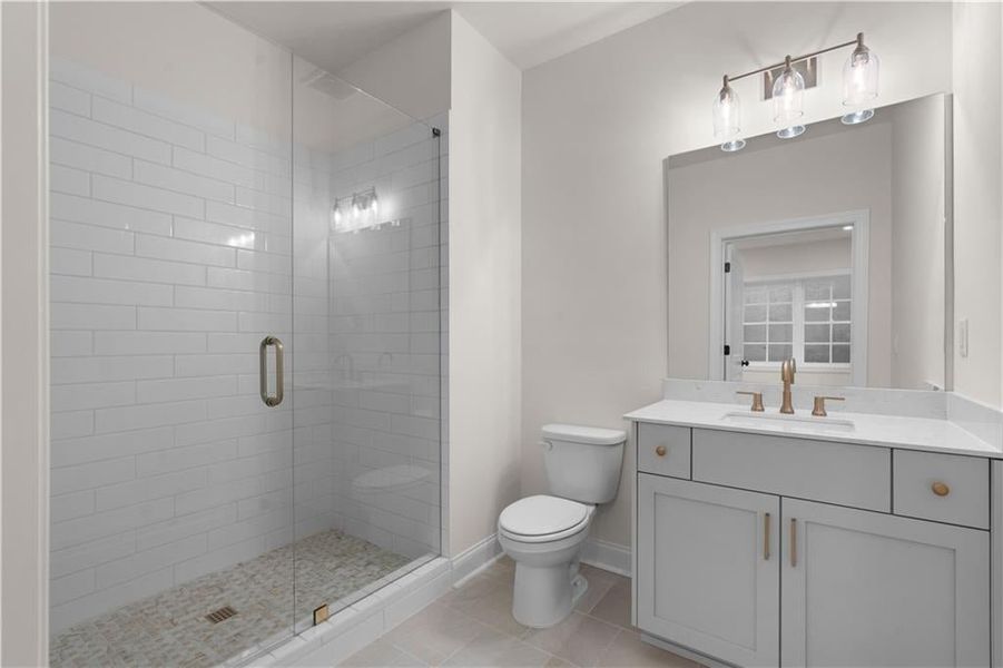 Full bathroom with vanity, a shower stall, and light tile patterned flooring