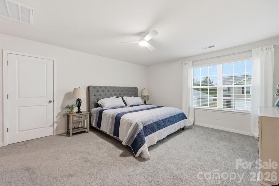 primary bedroom, walk in closet, ensuite with walk in shower, water closet, and linen closet.