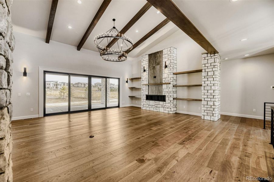 Great room with beamed ceiling, sliders to back patio