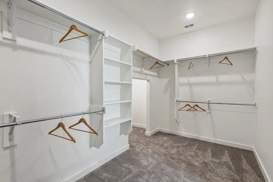 Primary Closet in the Wimbledon home plan by Trophy Signature Homes – REPRESENTATIVE PHOTO Primary Closet in the Wimbledon home plan by Trophy Signature Homes – REPRESENTATIVE PHOTO