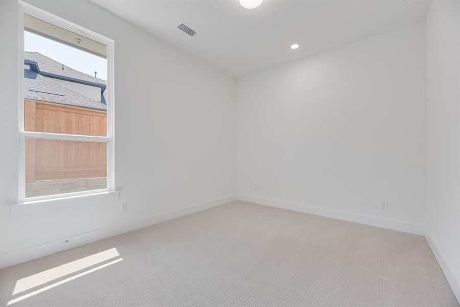 Spare room with light colored carpet and recessed lighting