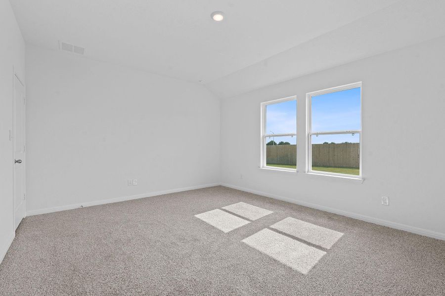Spare room with vaulted ceiling, light colored carpet, and recessed lighting Spare room with vaulted ceiling, light colored carpet, and recessed lighting