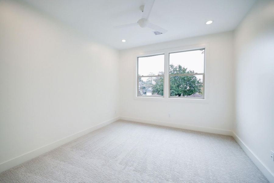 Secondary Bedroom #2 features large windows, ceiling fan, and a neutral color palette. *Previous Project*
