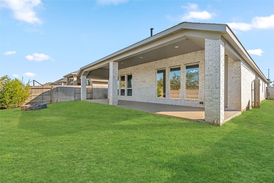 Angled exterior view showing the full depth of the home and the large patio.