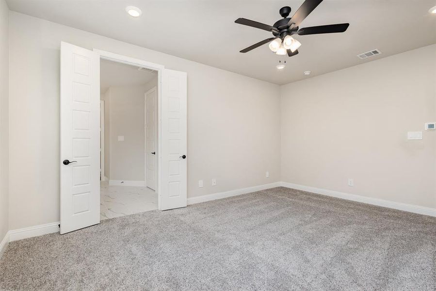 Empty room featuring light carpet, recessed lighting, and ceiling fan