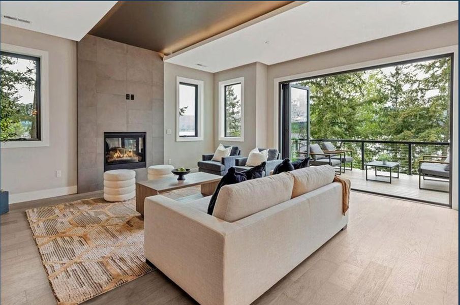 Living area featuring a tile fireplace and light wood-style flooring