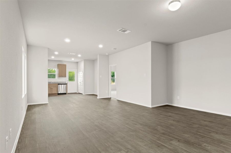 Unfurnished living room with recessed lighting and dark wood-type flooring
