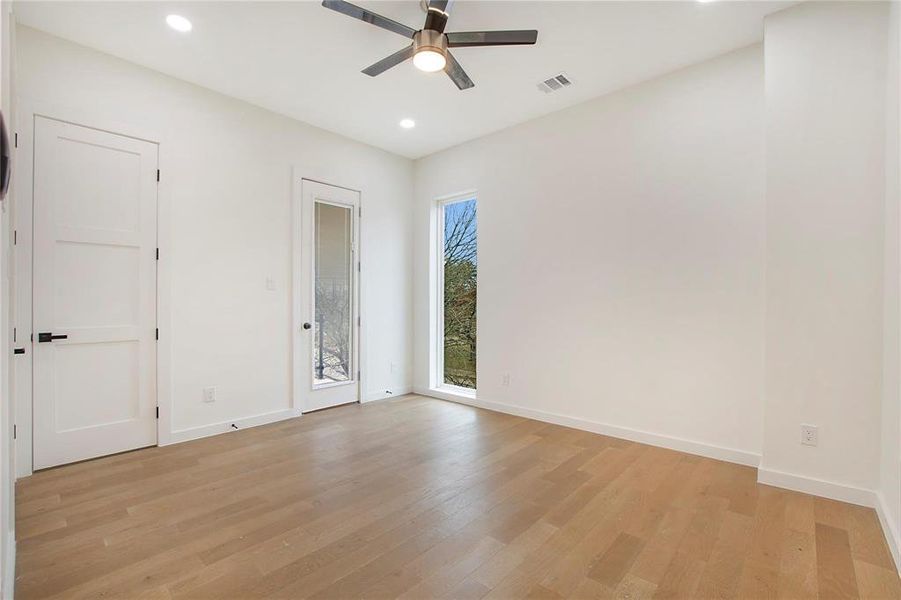 Empty room featuring ceiling fan and light hardwood / wood-style flooring