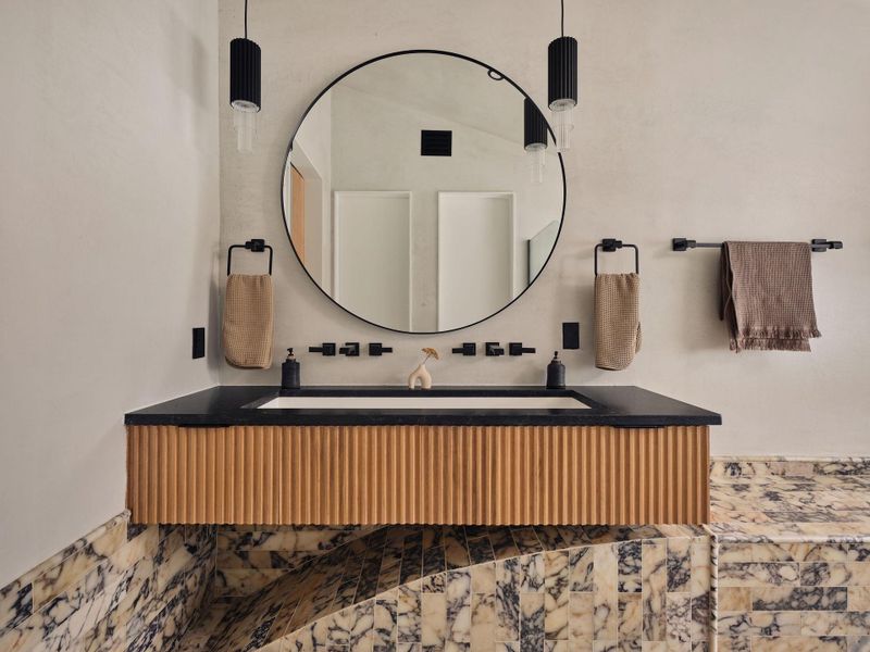 The primary bathroom suite offers a stunning backdrop for theCalacatta Viola marble tile The primary bathroom suite offers a stunning backdrop for theCalacatta Viola marble tile