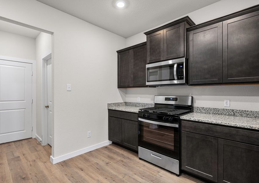 The kitchen has beautiful wood cabinetry.