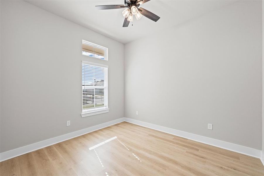 Empty room featuring light wood-type flooring and ceiling fan Empty room featuring light wood-type flooring and ceiling fan