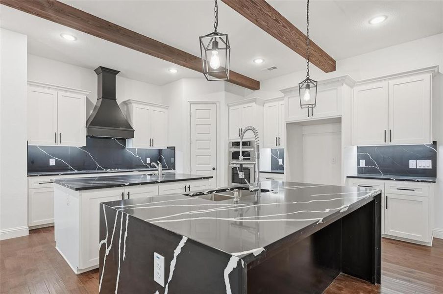 Kitchen featuring backsplash, recessed lighting, wall chimney exhaust hood, dark wood-style floors, and decorative light fixtures