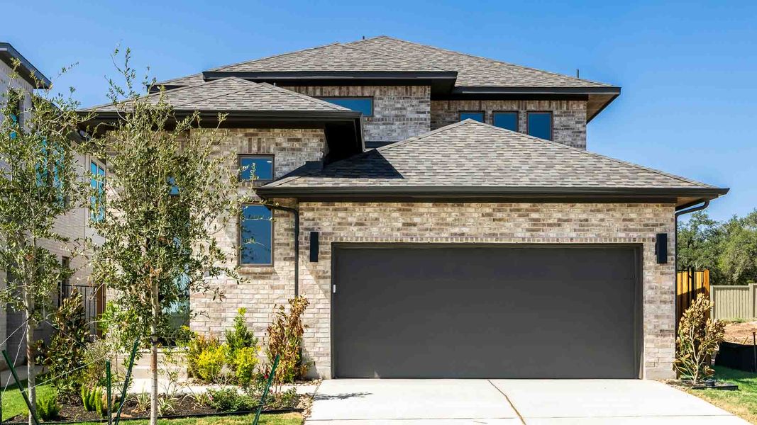 Front exterior of a new home in Santa Rita Ranch - Tierra Rosa, Liberty Hill, TX, highlighting curb appeal (Image 1). Front exterior of a new home in Santa Rita Ranch - Tierra Rosa, Liberty Hill, TX, highlighting curb appeal (Image 1).