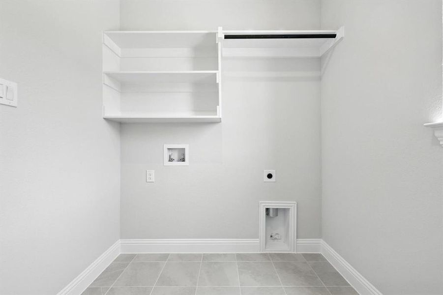 Laundry room with hookup for an electric dryer, washer hookup, and tile patterned floors Laundry room with hookup for an electric dryer, washer hookup, and tile patterned floors