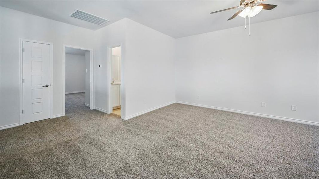 Carpeted spare room with a ceiling fan and baseboards Carpeted spare room with a ceiling fan and baseboards