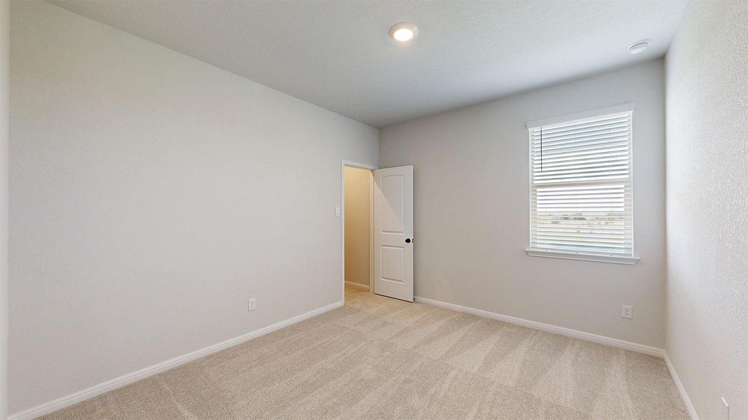 Empty room featuring baseboards and light colored carpet Empty room featuring baseboards and light colored carpet