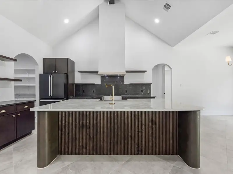 This amazing kitchen is a perfect blend of luxury and efficiency. Your floating shelves are perfect to display your gorgeous decor. Builder is willing to add cabinets if needed!