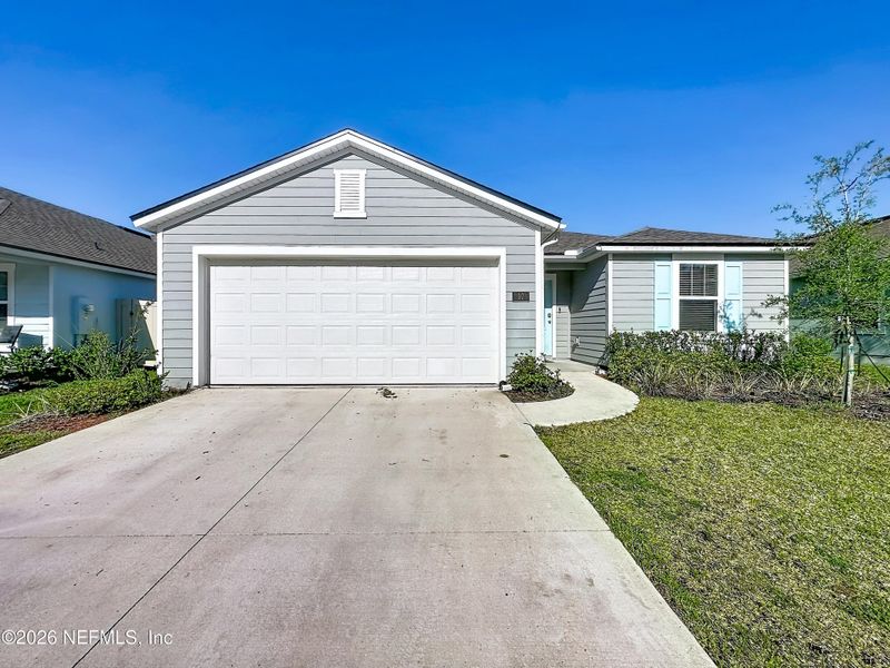 Front exterior of a new home in Dorado at Entrada, St. Augustine, FL, highlighting curb appeal (Image 27).