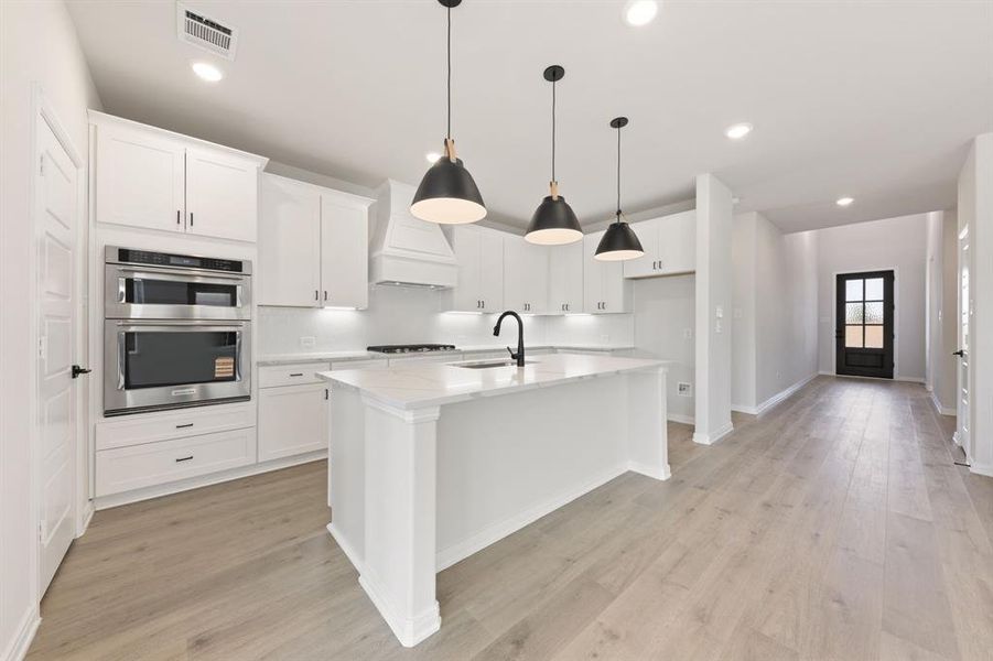 Featuring a spacious kitchen island that overlooks the family and dining rooms, the chef in the family will never be left out of the party in this dream kitchen!