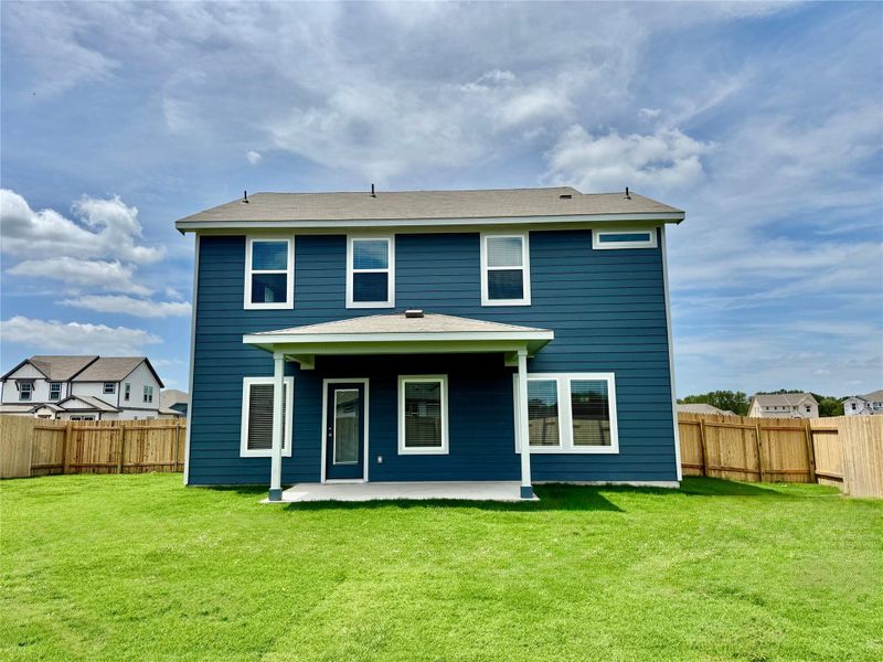 Rear view of house featuring a fenced backyard and a patio area Rear view of house featuring a fenced backyard and a patio area