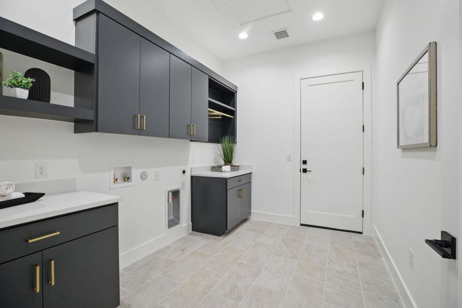 Laundry area with cabinet space, electric dryer hookup, hookup for a washing machine, baseboards, and recessed lighting