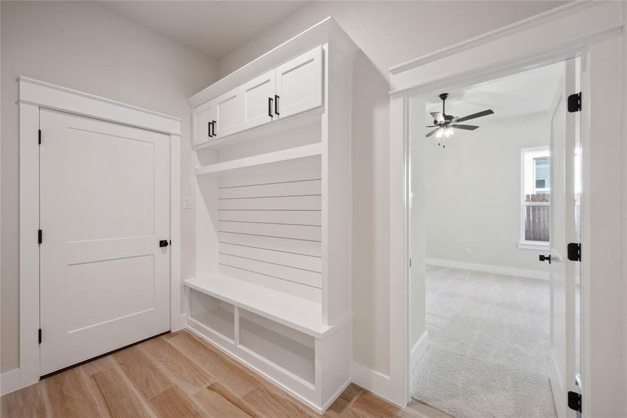 Mudroom with light hardwood / wood-style floors and ceiling fan