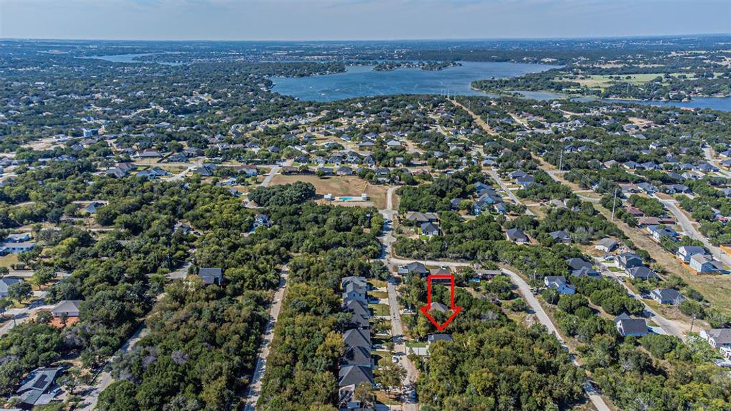 View of property location with a tree filled landscape and nearby suburban area
