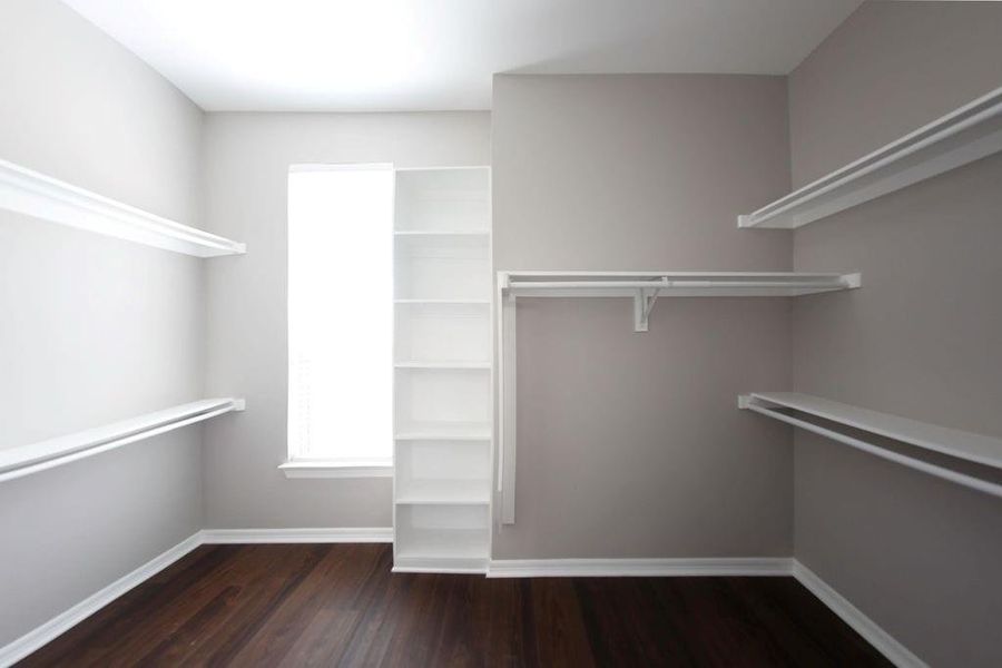 Walk in closet with dark wood-type flooring Walk in closet with dark wood-type flooring