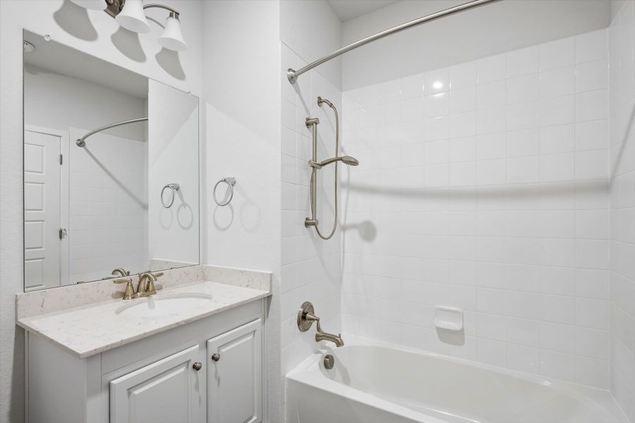 A bathroom with a sink and a shower unit. A bathroom with a sink and a shower unit.