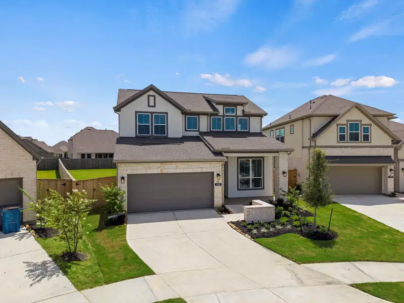 Front exterior of a new home in Bridgeland 45's, Cypress, TX, highlighting curb appeal (Image 2). Front exterior of a new home in Bridgeland 45's, Cypress, TX, highlighting curb appeal (Image 2).