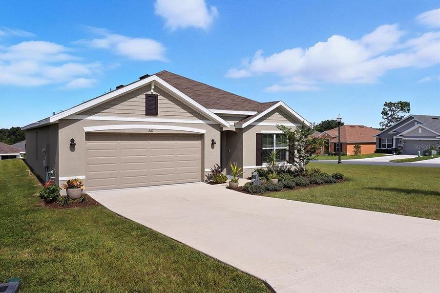 Front exterior of a new home in Fairways at Twisted Oaks, Beverly Hills, FL, highlighting curb appeal (Image 2).