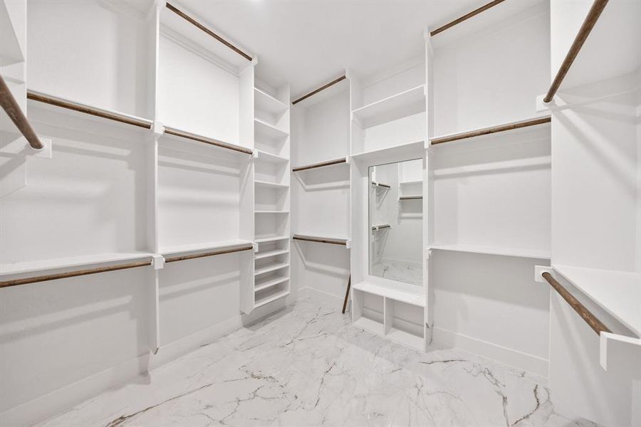 Spacious closet with light marble finish flooring
