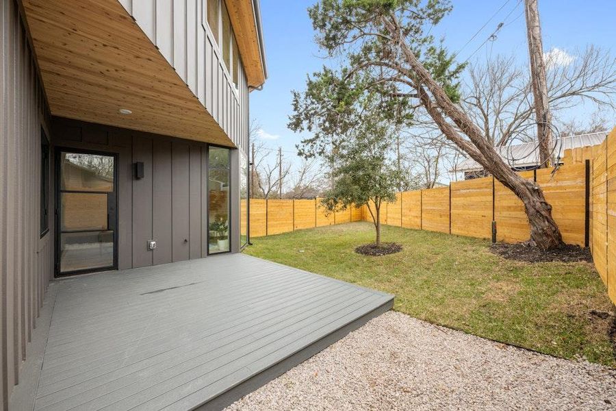 Fenced backyard featuring a wooden deck