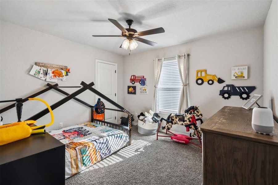 Bedroom featuring ceiling fan and carpet