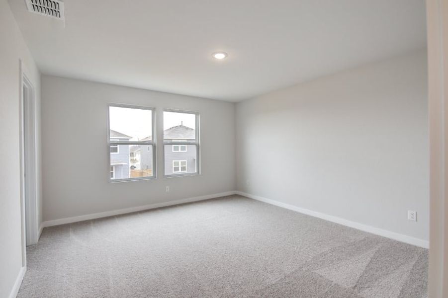 A room with a window and a carpet. A room with a window and a carpet.