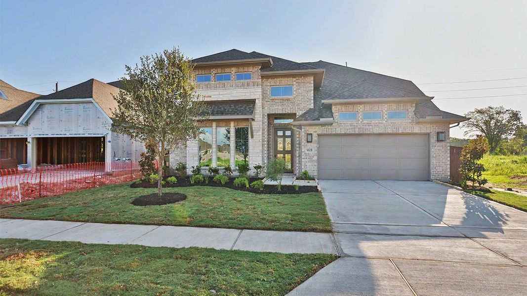 Front exterior of a new home in Meridiana, Manvel, TX, highlighting curb appeal (Image 2).