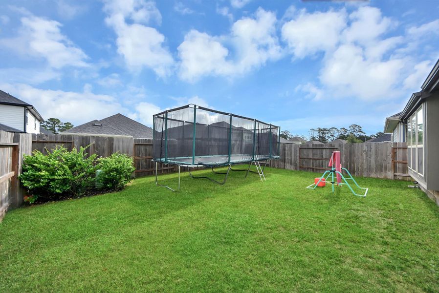 Another view of backyard. Featuring space to build a pool or even a playground
