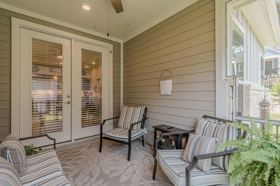 Sunroom / solarium featuring french doors and a ceiling fan