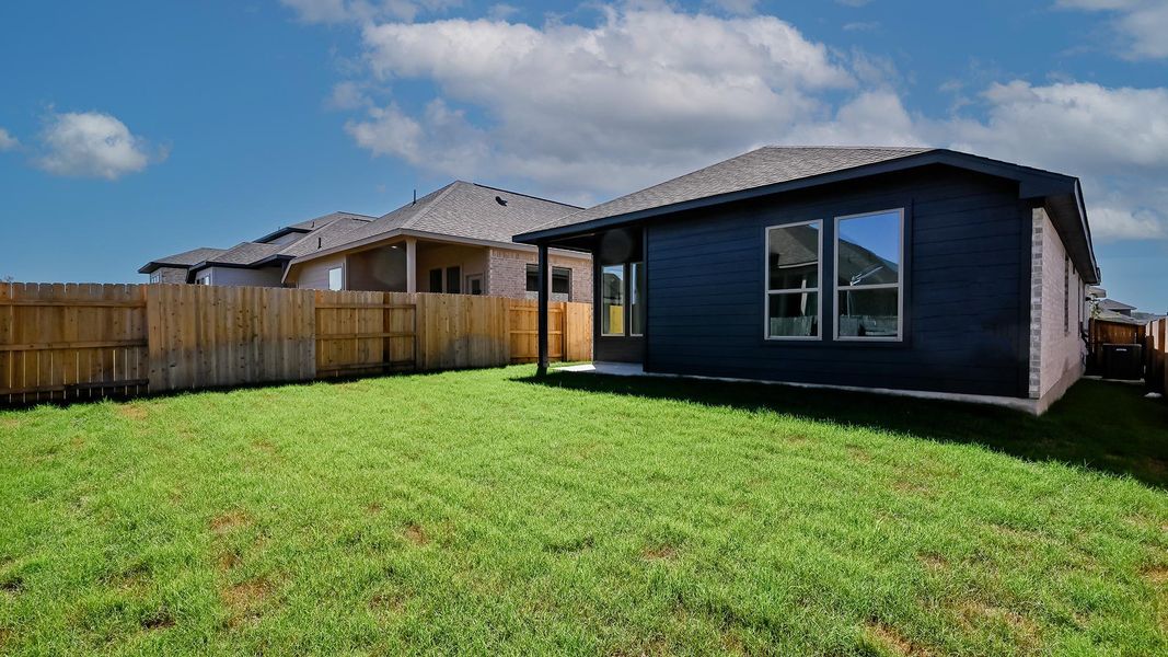 Back of property featuring a fenced backyard, a shingled roof, and brick siding Back of property featuring a fenced backyard, a shingled roof, and brick siding
