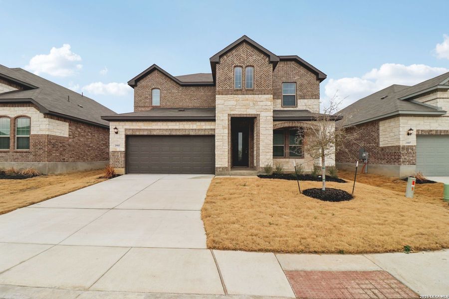 Front exterior of a new home in Fox Falls, Boerne, TX, highlighting curb appeal (Image 1). Front exterior of a new home in Fox Falls, Boerne, TX, highlighting curb appeal (Image 1).