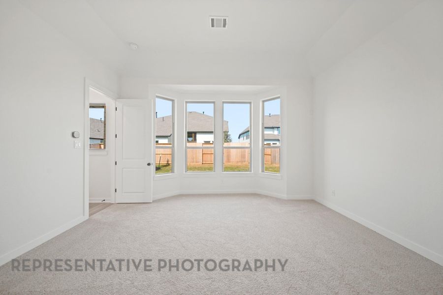 Representative of Primary bedroom with bay window.