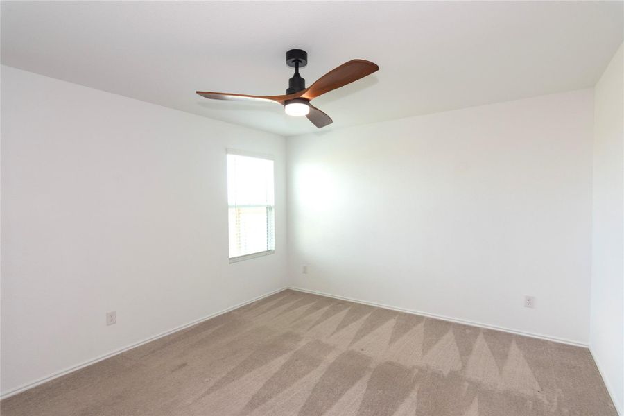 The primary bedroom has plenty of space for a king-sized bed