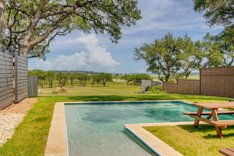 Enjoy wide-open Hill Country views from this beautifully landscaped backyard—perfect for relaxing, entertaining, or simply soaking in the peaceful Canyon Lake surroundings. Plenty of space to gather and unwind under the Texas sky.